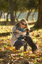 Caucasian woman playing with dog in park