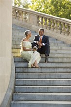 Black couple sitting on stone staircase