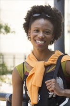 Portrait of smiling African American woman carrying purse