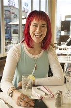 Caucasian woman laughing in restaurant