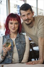 Portrait of Caucasian couple with white wine in restaurant