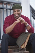 Portrait of African American man sitting on stoop