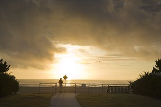 Man watching sunset at waterfront
