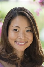 Portrait of Asian woman smiling outdoors