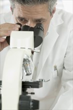 Man looking through microscope