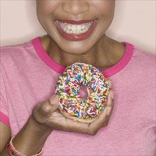 Close up of woman holding donut
