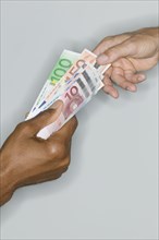 Close up of hands exchanging money