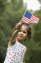Young girl flying American flag