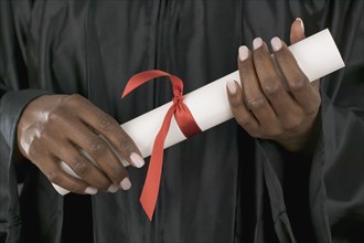 Hands holding diploma