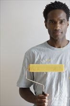 Portrait of man with paint roller