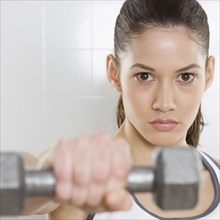Portrait of teenage girl lifting weights