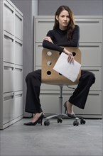 Portrait of businesswoman sitting in chair