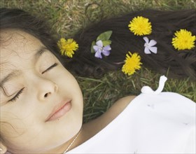 Sleeping girl with flowers in her hair