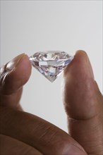 Close up of hand holding diamond