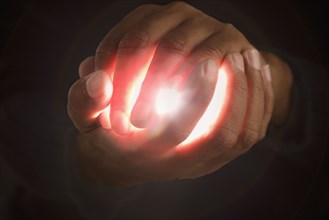 Close up of hands holding light
