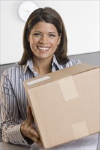 Portrait of woman holding box