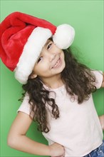 Portrait of girl smiling while wearing Santa hat