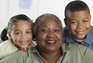 Senior woman smiling with her grandchildren
