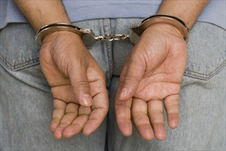 Close up of male hands in handcuffs