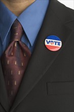 Close up of businessman with vote pin on lapel