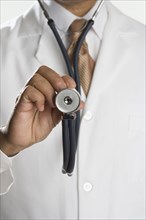 Close up of male doctor's hand holding stethoscope