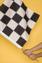 Close up of man waving checkered flag