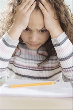 Young girl thinking about homework