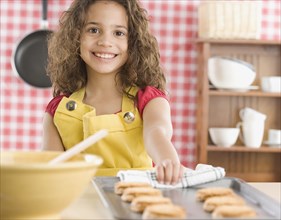 Young girl baking cookies