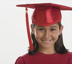 Hispanic girl wearing graduation cap