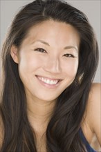 Close up of young Asian woman smiling