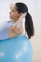 African woman using exercise ball