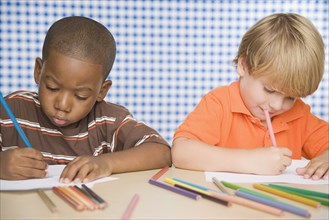 Two young boys coloring
