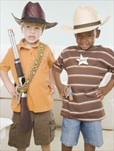 Two young boys dressed as cowboys
