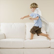 Young boy playing on sofa