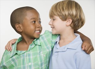 Two young boys smiling at each other