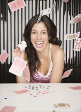 Hispanic woman throwing playing cards