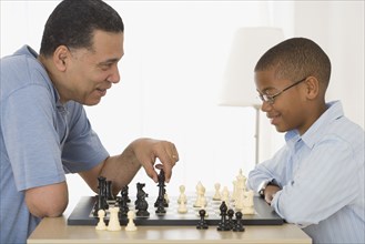 African father and son playing chess