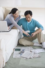 Asian couple sitting in living room