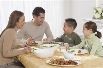 Hispanic family eating at dinner table
