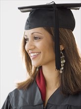 Indian woman wearing graduation cap and gown