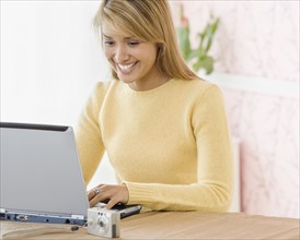 Hispanic woman typing on laptop