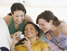 Three young women looking at video camera