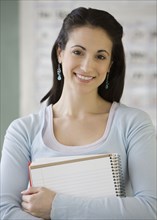 Young woman holding notebook