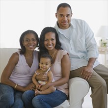 Multi-generational African American family on sofa