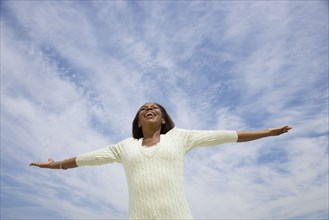 African American woman with arms outstretched