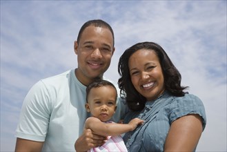 African American parents and baby outdoors