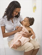 African American mother drying off baby