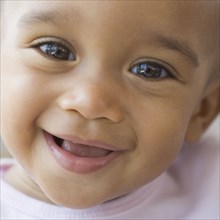 Close up of African American baby smiling