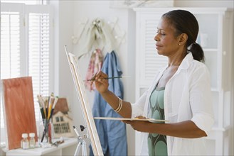 Senior African American woman painting