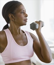 Senior African American woman lifting weights